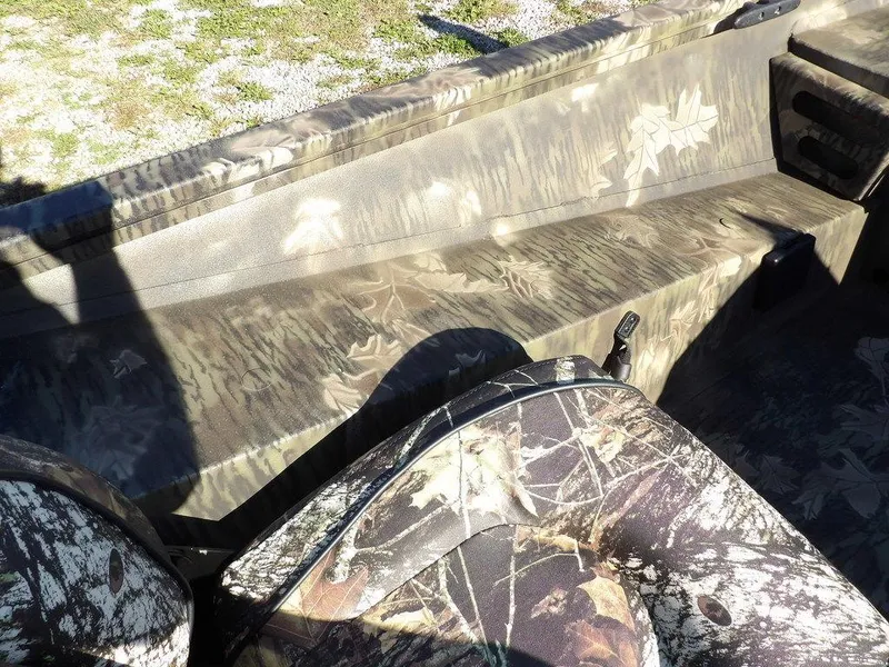 Slide: The Image of 2025 Crestliner XFC 189 boat interior with camouflage design, featuring seating and storage areas. - 20