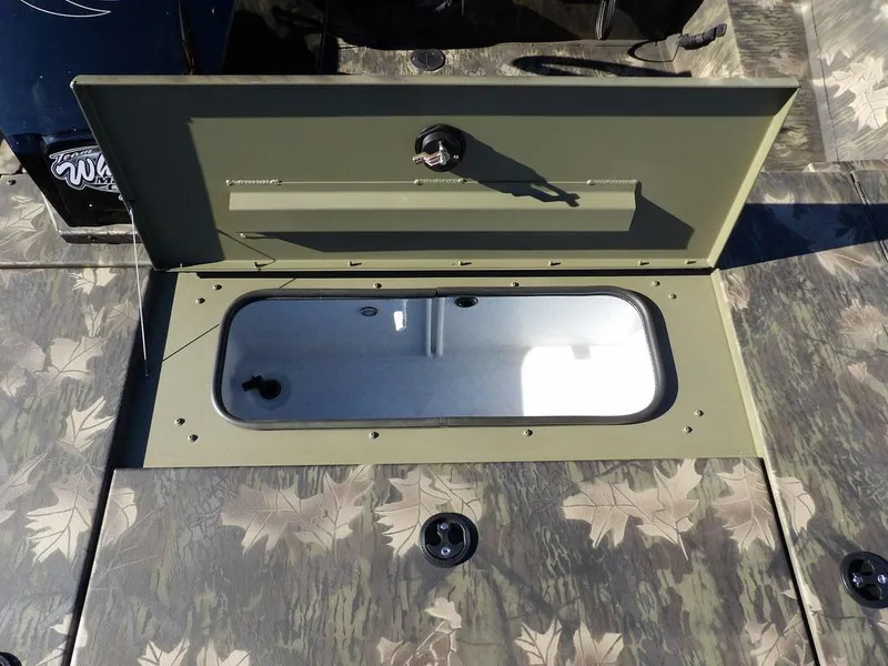 Slide: The Image of 2025 Crestliner XFC 189 boat storage compartment with camouflage design. - 24