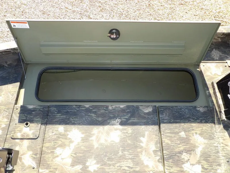 Slide: The Image of 2025 Crestliner XFC 189 boat storage compartment with open lid, showcasing interior space. - 26