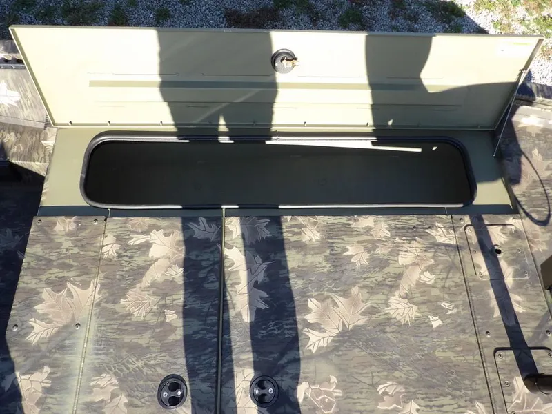 Slide: The Image of 2025 Crestliner XFC 189 boat storage compartment with open lid, showcasing interior space. - 27