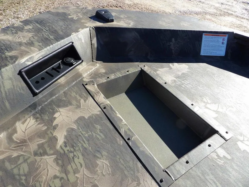 Slide: The Image of 2025 Crestliner XFC 189 boat deck with camo pattern and storage compartment. - 28