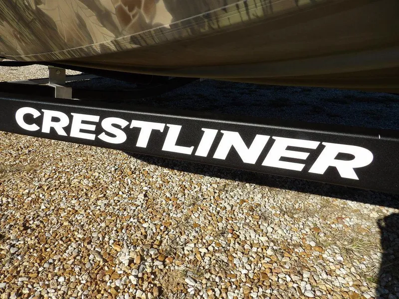 Slide: The Image of Crestliner XFC 189 boat trailer, 2025 model, on gravel surface. - 31