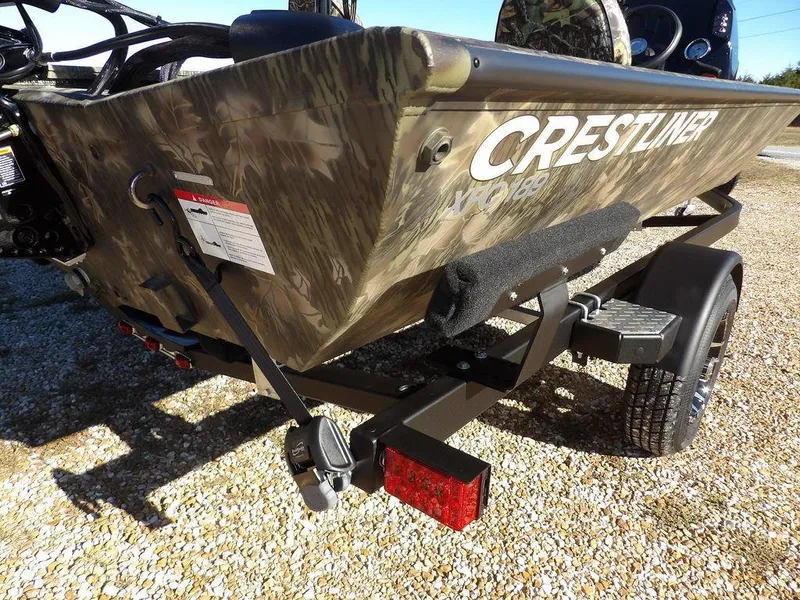 Slide: The Image of 2025 Crestliner XFC 189 boat on trailer, camo design, rear view. - 34