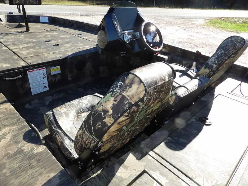 Slide: The Image of 2025 Crestliner XFC 189 boat interior with camouflage seats and steering console. - 9
