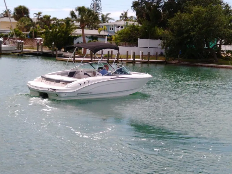 Slide: The Image of 2019 Chaparral 21 H2O Sport boat cruising on a calm waterway. - 1