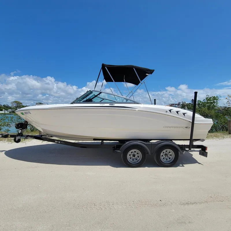 Slide: The Image of 2019 Chaparral 21 H2O Sport boat on trailer under clear blue sky. - 2