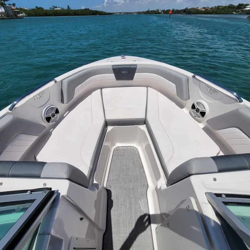 Slide: The Image of 2019 Chaparral 21 H2O Sport boat interior on a sunny day, surrounded by blue water. - 4