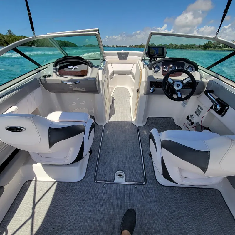 Slide: The Image of 2019 Chaparral 21 H2O Sport boat interior with dual seats and steering wheel. - 5
