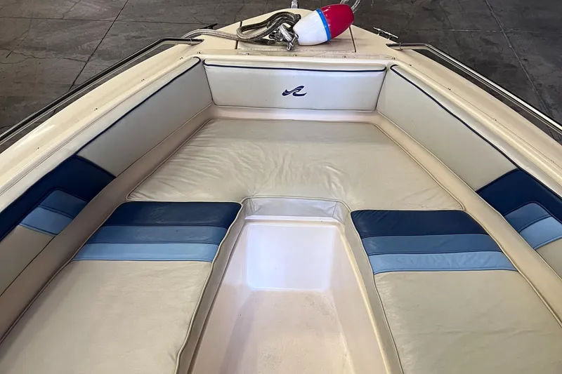 Slide: The Image of 1987 Sea Ray 23 Sorrento boat interior with beige and blue seating. - 14