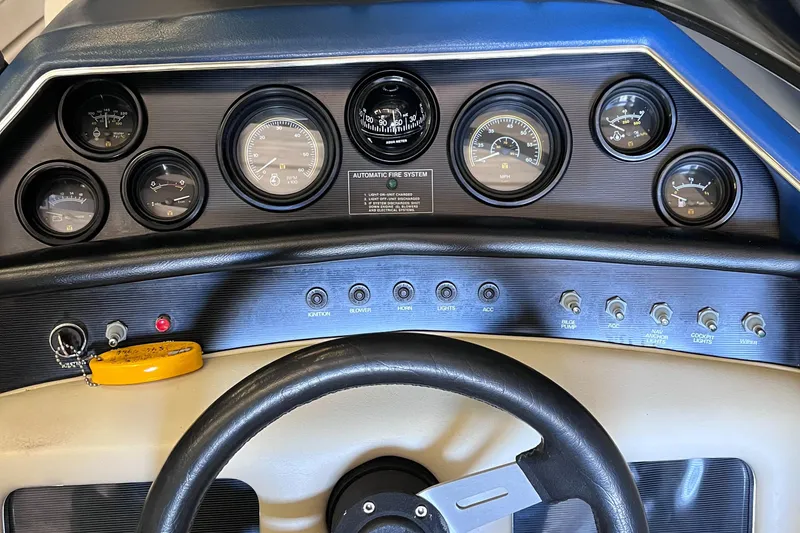 Slide: The Image of Dashboard of a 1987 Sea Ray 23 Sorrento boat with gauges and controls. - 16
