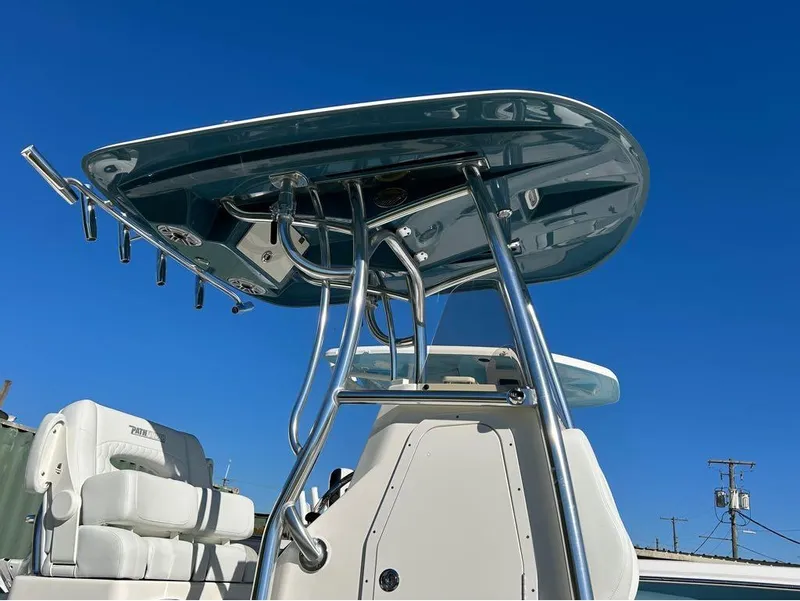 Slide: The Image of 2025 Pathfinder 2600 TRS boat with T-top and seating against clear blue sky. - 3