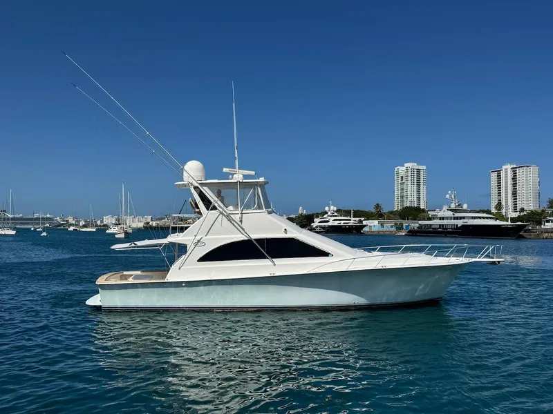 Slide: The Image of 2000 Ocean Yachts 48 Convertible in marina, clear blue sky, calm water. - 13