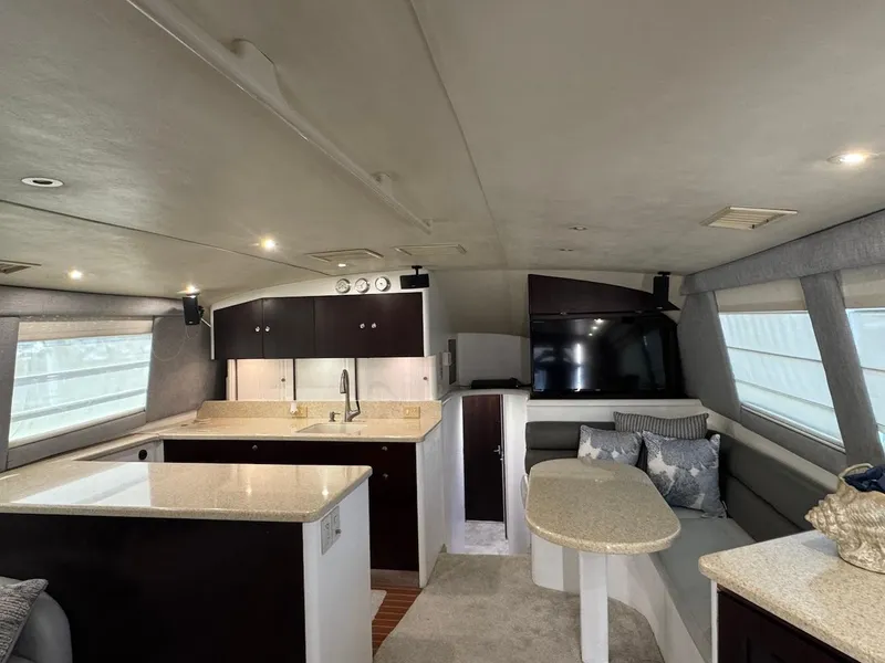 Slide: The Image of Interior of 2000 Ocean Yachts 48 Convertible with modern kitchen and seating area. - 14