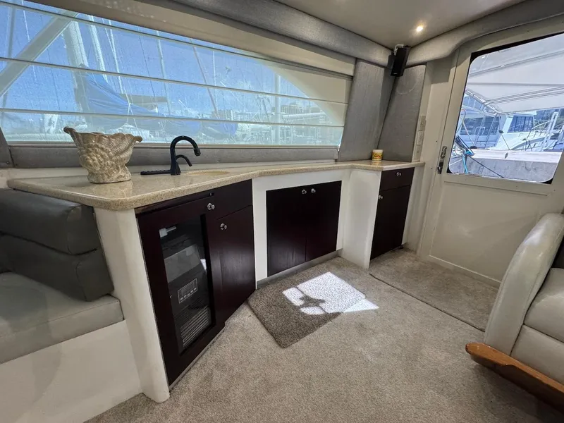 Slide: The Image of Interior of 2000 Ocean Yachts 48 Convertible, featuring a modern kitchen area with ample natural light. - 16