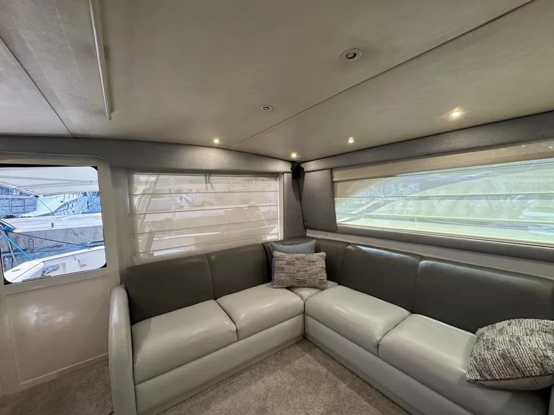 Slide: The Image of Interior of 2000 Ocean Yachts 48 Convertible with gray leather seating and large windows. - 18