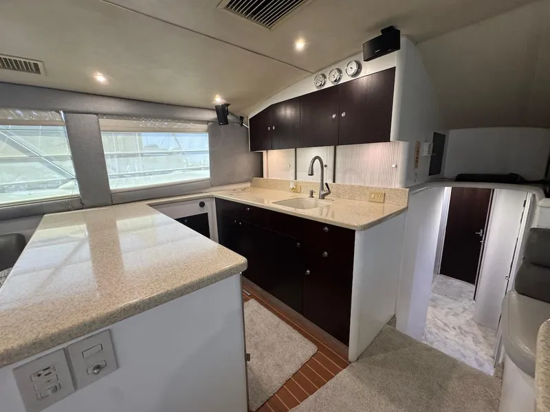 Slide: The Image of Interior of 2000 Ocean Yachts 48 Convertible, featuring modern kitchen and sleek cabinetry. - 19