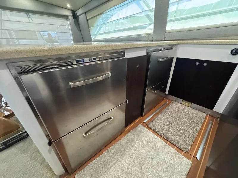 Slide: The Image of Interior of 2000 Ocean Yachts 48 Convertible, featuring stainless steel appliances and modern design. - 20