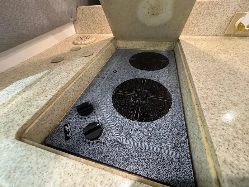 Slide: The Image of Stovetop in 2000 Ocean Yachts 48 Convertible kitchen, featuring two burners and granite countertop. - 21