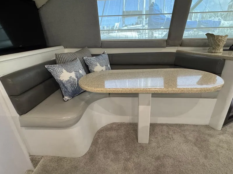 Slide: The Image of Interior of 2000 Ocean Yachts 48 Convertible with cushioned seating and table. - 24