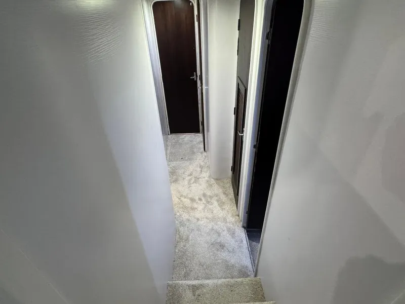 Slide: The Image of Interior hallway of 2000 Ocean Yachts 48 Convertible, featuring carpeted flooring and doorways. - 25