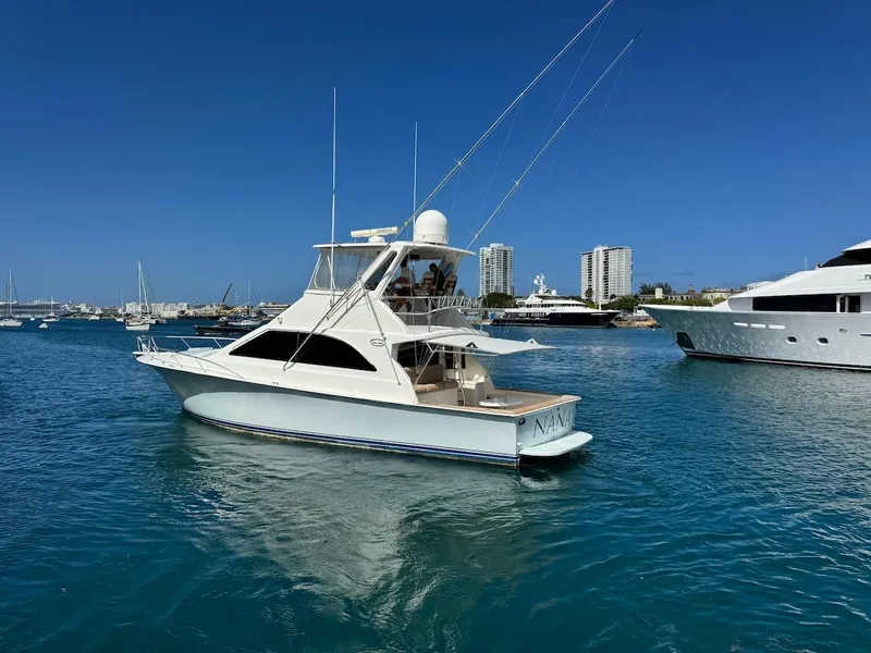 Slide: The Image of 2000 Ocean Yachts 48 Convertible in a marina, clear blue sky and water. - 3