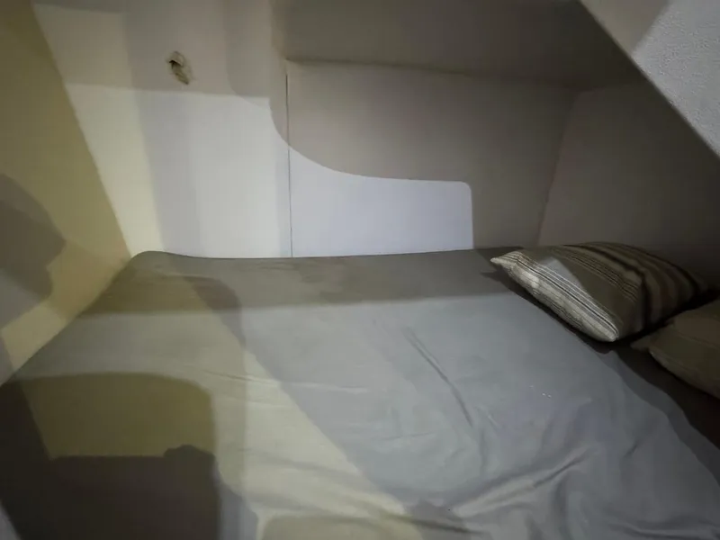 Slide: The Image of Small cabin bed in 2000 Ocean Yachts 48 Convertible, featuring simple bedding and pillows. - 30