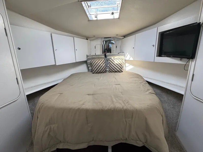 Slide: The Image of Interior cabin of 2000 Ocean Yachts 48 Convertible with bed, storage, and TV. - 32