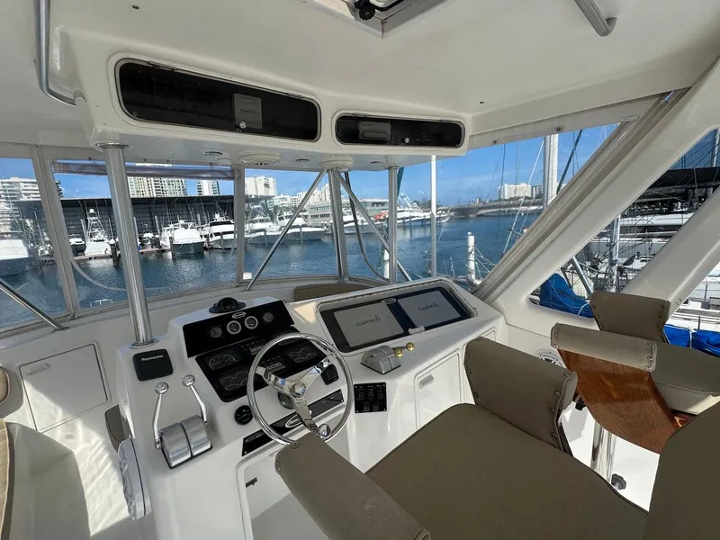 Slide: The Image of Helm of 2000 Ocean Yachts 48 Convertible with marina view. - 34