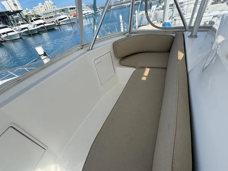 Slide: The Image of 2000 Ocean Yachts 48 Convertible boat interior with beige seating at marina. - 37