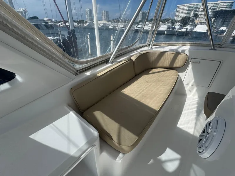 Slide: The Image of Interior seating area of 2000 Ocean Yachts 48 Convertible, with marina view. - 38