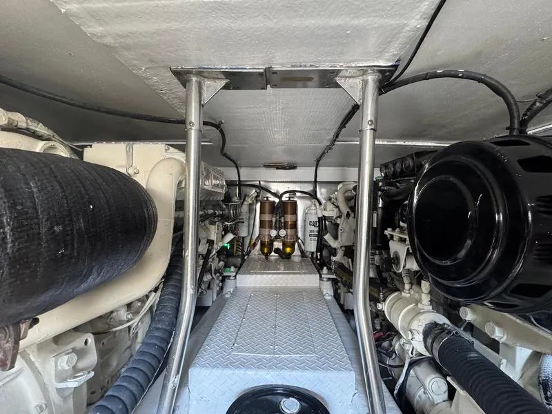 Slide: The Image of Engine room of 2000 Ocean Yachts 48 Convertible, showcasing mechanical components and piping. - 40