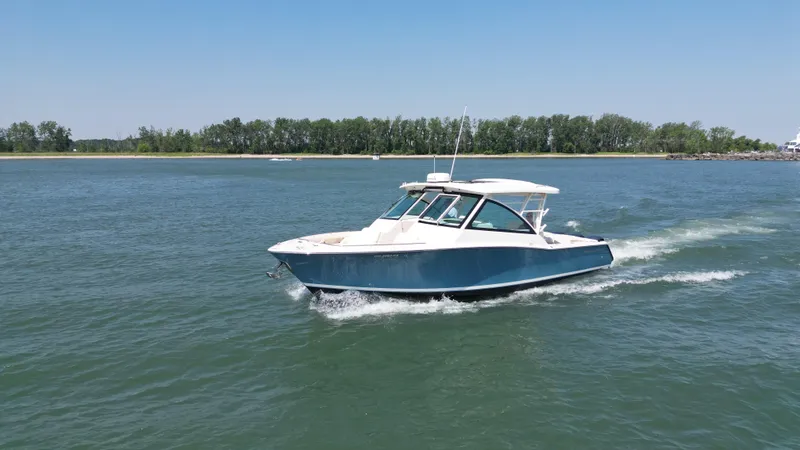 The Image of 2019 Grady-White Freedom 375 cruising on a calm lake under clear blue skies. - 0