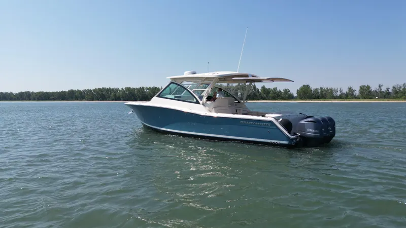 Slide: The Image of 2019 Grady-White Freedom 375 boat on calm water, clear sky background. - 1
