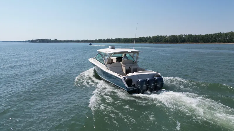 Slide: The Image of 2019 Grady-White Freedom 375 boat cruising on a calm lake. - 11