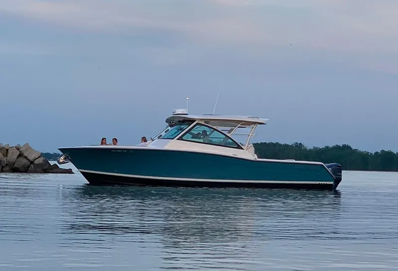 Slide: The Image of 2019 Grady-White Freedom 375 boat on calm water, side view. - 15