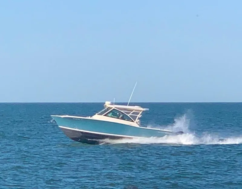 Slide: The Image of 2019 Grady-White Freedom 375 boat cruising on open water. - 16