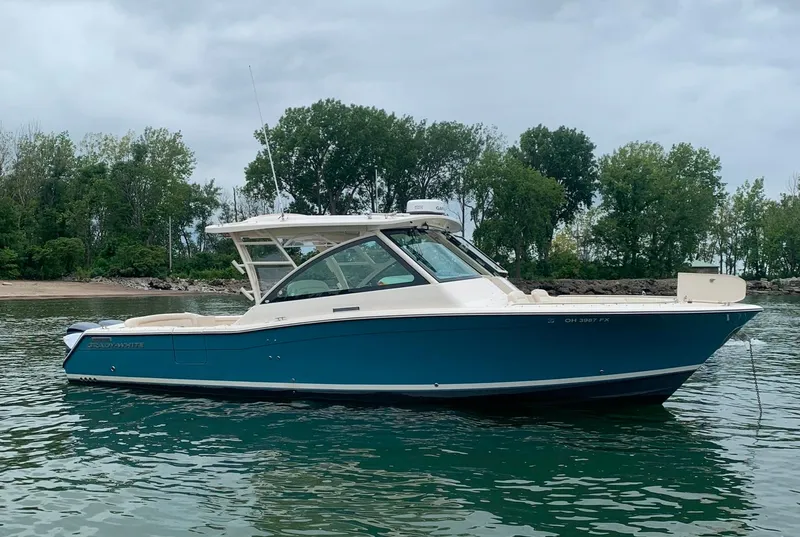 Slide: The Image of 2019 Grady-White Freedom 375 boat on calm water, with trees in the background. - 18