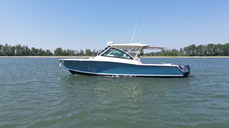 Slide: The Image of 2019 Grady-White Freedom 375 boat on calm water, clear sky background. - 2