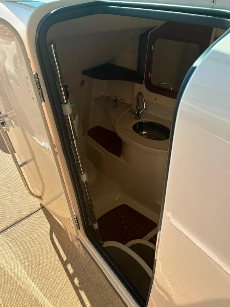 Slide: The Image of 2019 Grady-White Freedom 375 boat interior with compact bathroom and sink. - 24