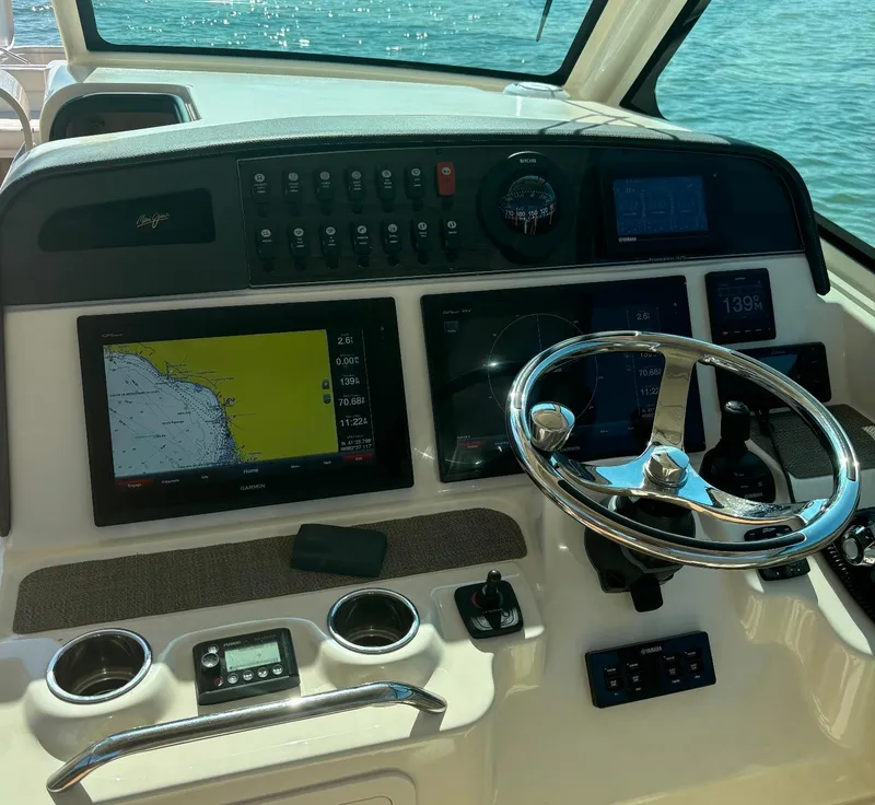 Slide: The Image of 2019 Grady-White Freedom 375 boat dashboard with navigation screens and steering wheel. - 25