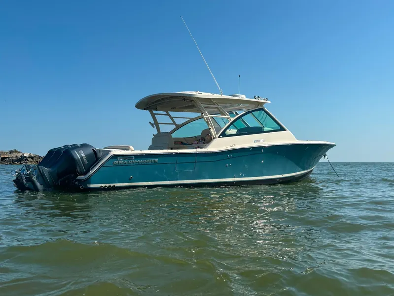 Slide: The Image of 2019 Grady-White Freedom 375 boat on calm water under clear blue sky. - 26