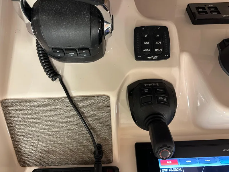 Slide: The Image of Control panel of 2019 Grady-White Freedom 375 boat with throttle and joystick. - 31