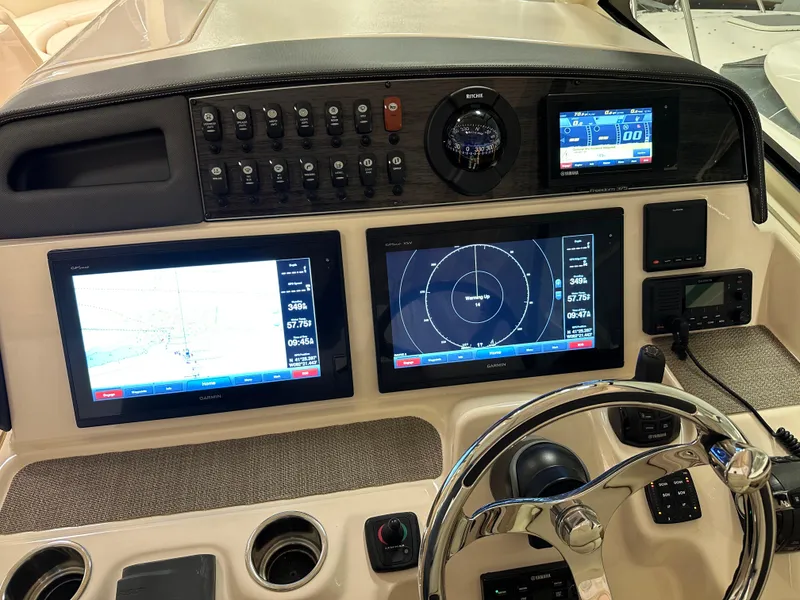 Slide: The Image of Control panel of 2019 Grady-White Freedom 375 boat with navigation screens and steering wheel. - 33
