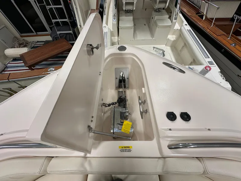 Slide: The Image of 2019 Grady-White Freedom 375 boat anchor compartment with open hatch, showcasing interior details. - 36