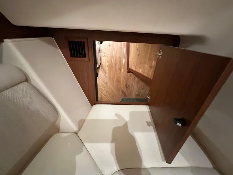 Slide: The Image of 2019 Grady-White Freedom 375 cabin interior with open wooden door and seating area. - 40