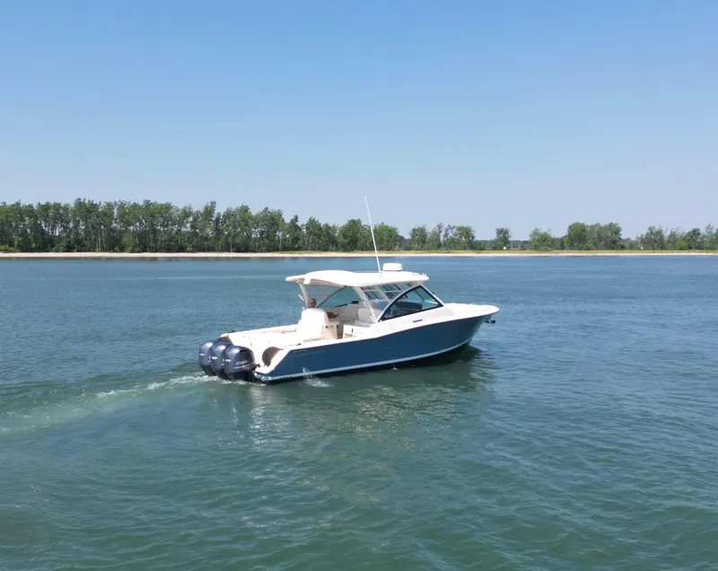 Slide: The Image of 2019 Grady-White Freedom 375 boat cruising on a calm lake. - 6