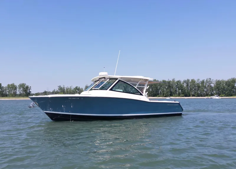 Slide: The Image of 2019 Grady-White Freedom 375 boat on calm water, clear sky background. - 7