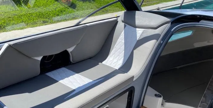 Slide: The Image of Interior of 2025 Hanover 305 Outboard Alpine Gray Ultimate Sport Edition boat, featuring sleek seating. - 4