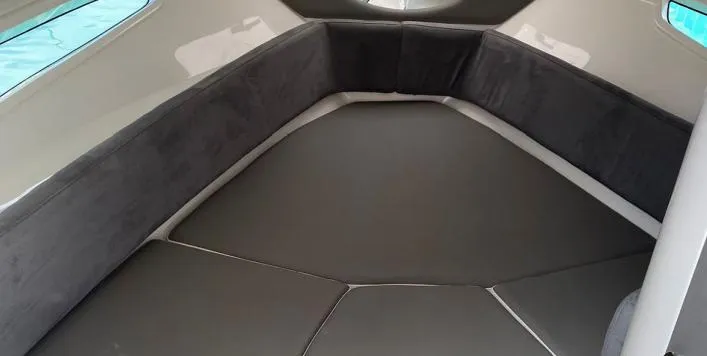 Slide: The Image of 2025 Hanover 305 Outboard Alpine Gray Ultimate Sport Edition interior cabin with cushioned seating. - 5