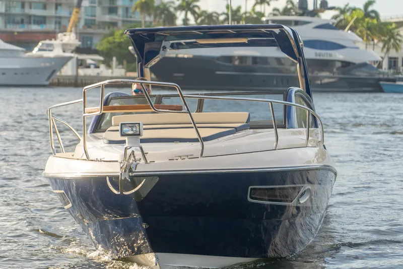 Slide: The Image of 2025 Hanover 305 Outboard Black & White T-Top Edition boat on water, front view. - 4